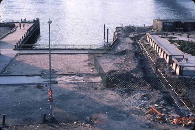 "Pier at Fulton Ferry Landing, on Water street looking west at the East River. Shows construction in progress on a park deck."